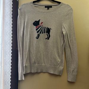 This is a grey sweater with a cute dog on it.